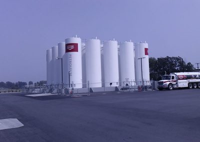 twenty white oil tanks lined up