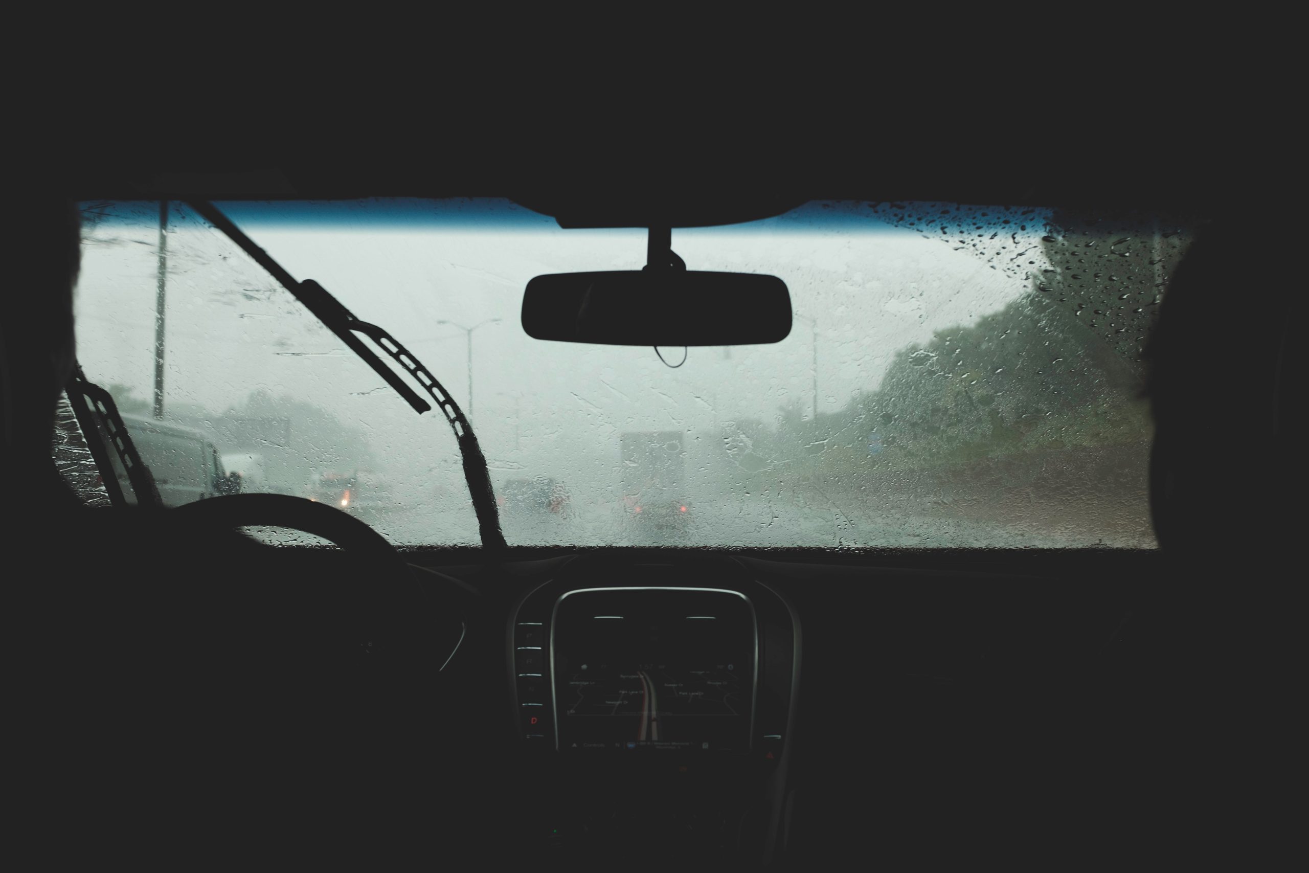interior of a car looking out onto the road on a rainy day