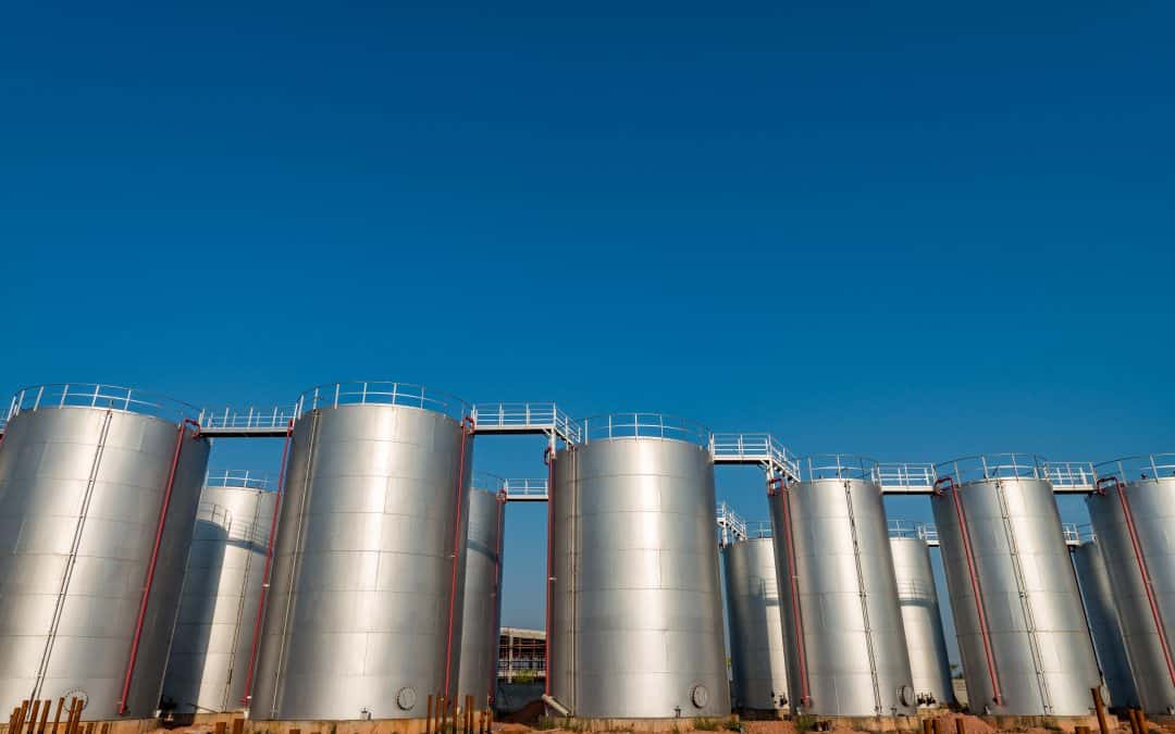 several silver oil storage tanks on a sunny day