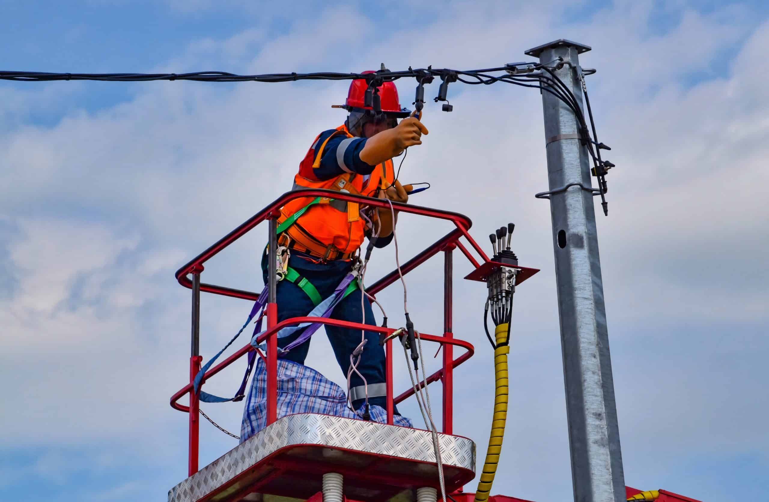 repair man fixing a power-line